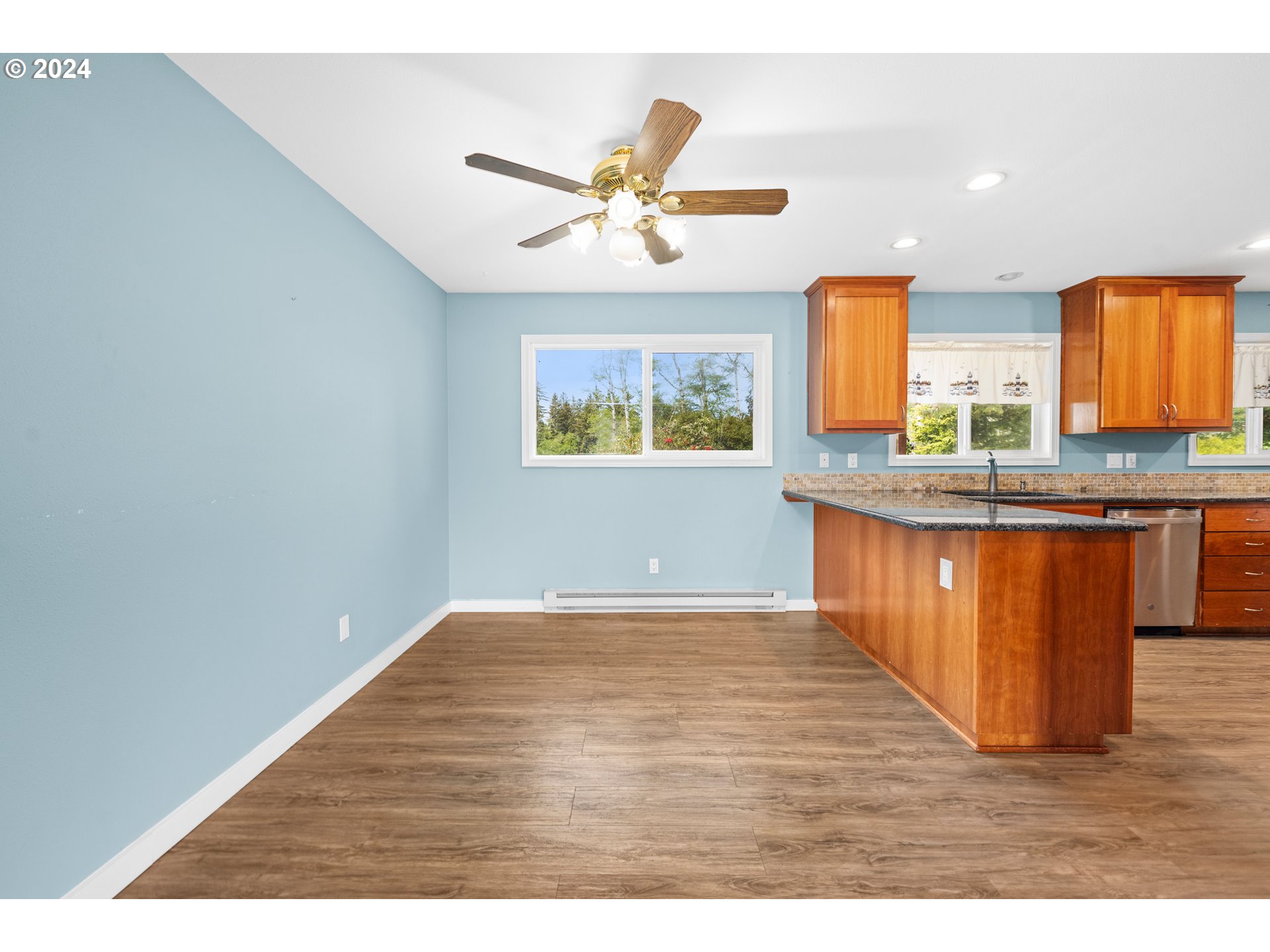 91897 Ridge Road Warrenton, OR 97146 - Photo 8 of 24 a view of kitchen with wooden floor and window