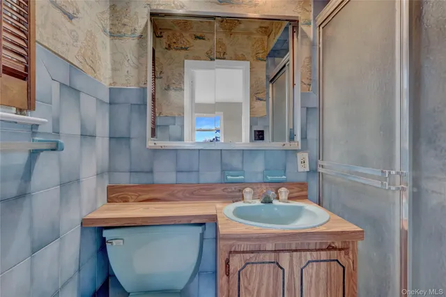a bathroom with a sink a mirror and bathtub