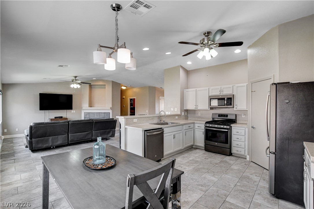 910 Cobblestone Cove Road North Las Vegas, NV 89081 - Photo 8 of 30 An open-concept living space integrates a well-appointed kitchen with a comfortable relaxation area.