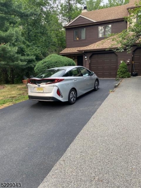 39 Patriots Road Morris Plains, NJ 07950 - Photo 2 of 14 a car parked in front of a house
