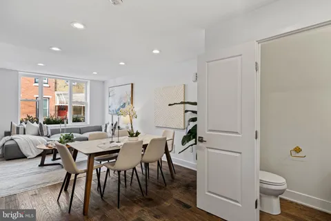 a view of a dining room with furniture and a potted plant