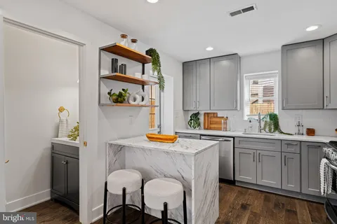 a kitchen with stainless steel appliances granite countertop a sink cabinets and window