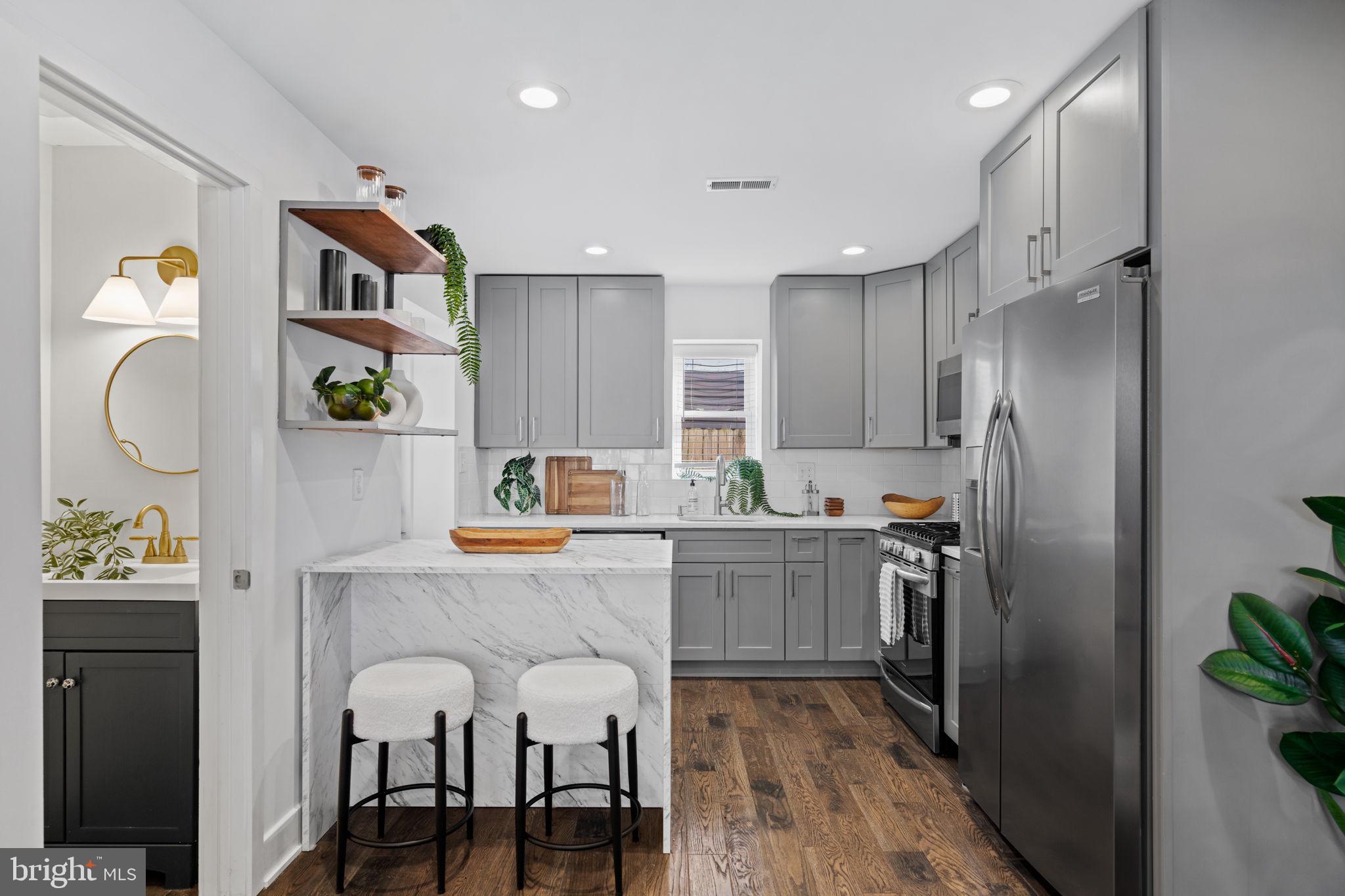 1629 South Camac Street Philadelphia, PA 19148 - Photo 14 of 34 a kitchen with stainless steel appliances granite countertop a refrigerator and a stove top oven