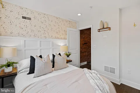 a bedroom with furniture and a window