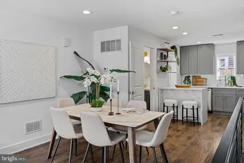 a view of a dining room with furniture and wooden floor
