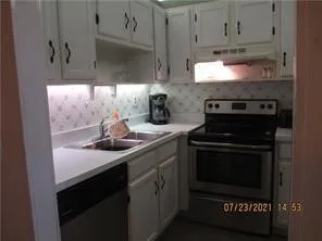 a kitchen with stainless steel appliances a stove and a microwave