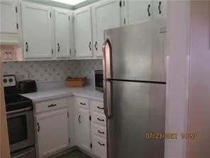 a kitchen with cabinets and stainless steel appliances