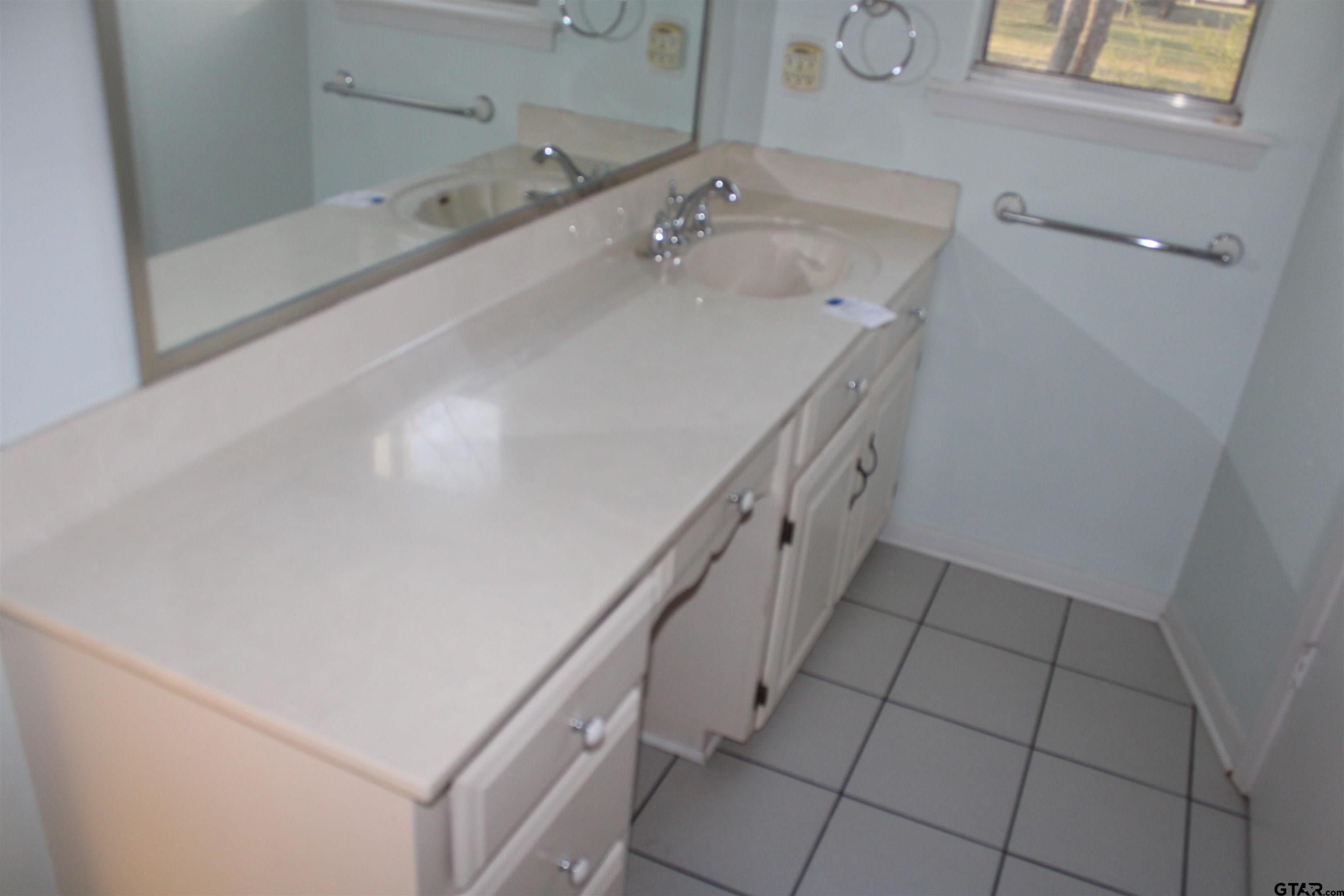 137 North Main Street Yantis, TX 75497 - Photo 14 of 22 a bathroom with a sink a vanity and mirror