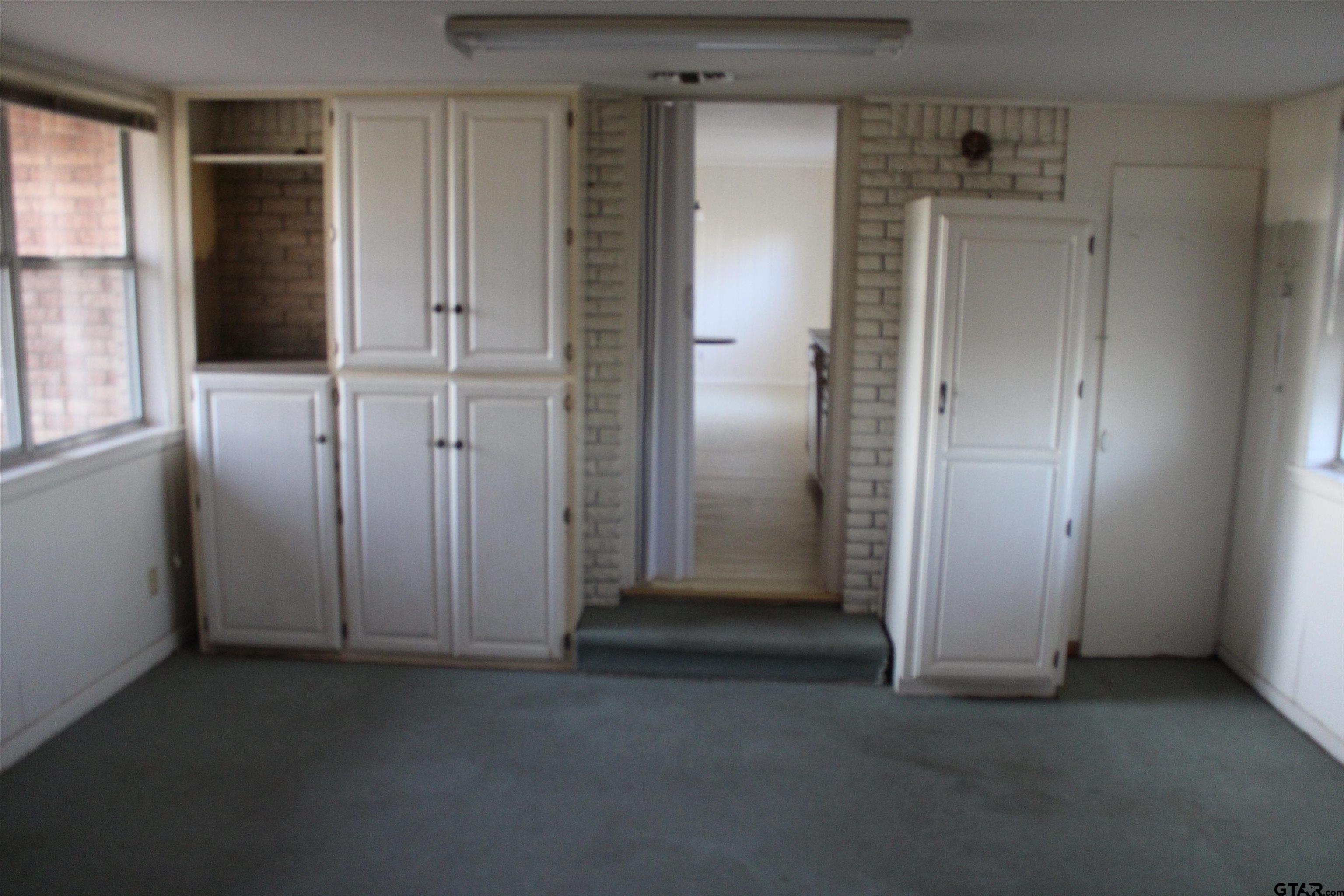 137 North Main Street Yantis, TX 75497 - Photo 4 of 22 an empty room with windows and closet