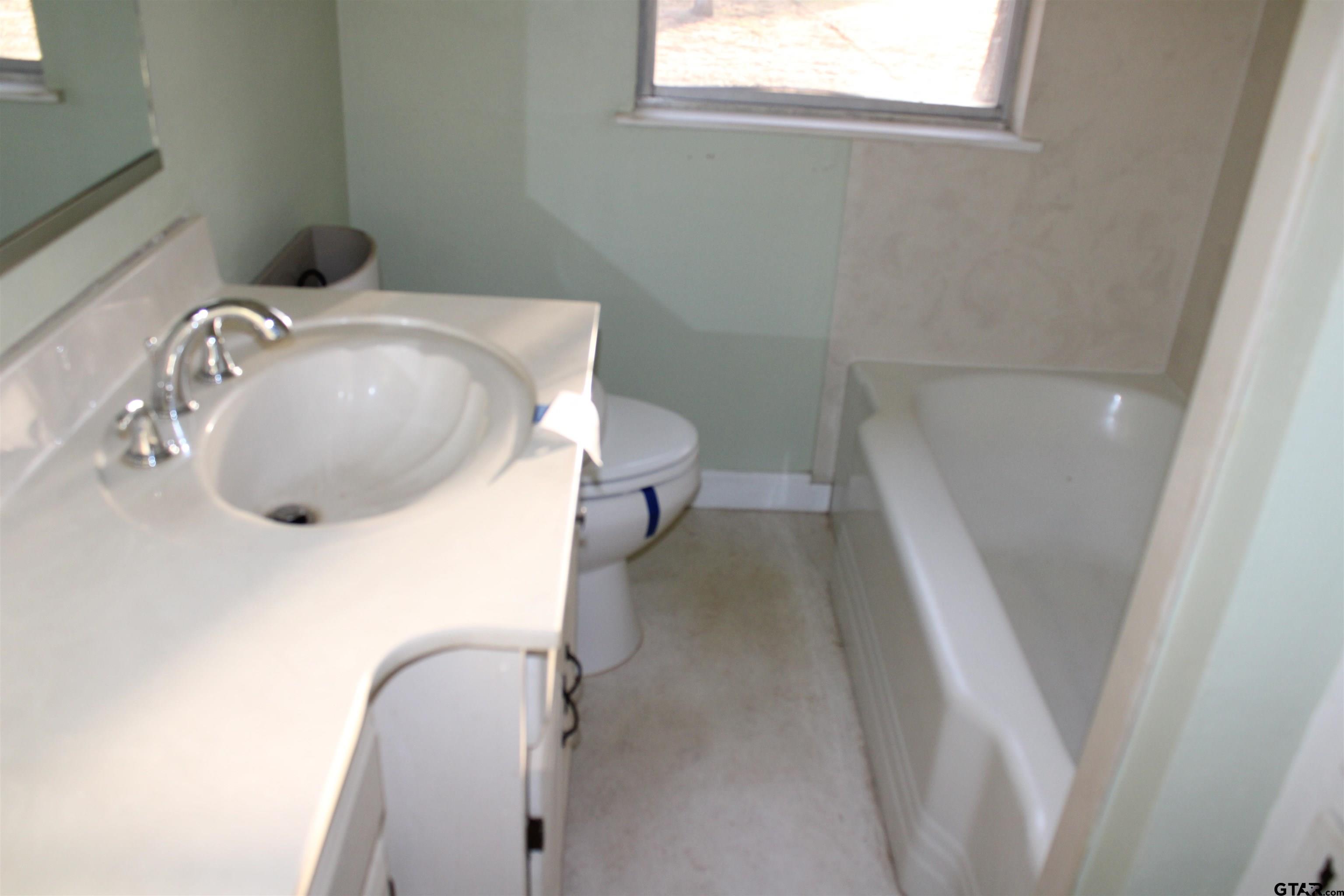 137 North Main Street Yantis, TX 75497 - Photo 9 of 22 a bathroom with a sink and toilet