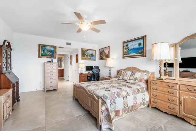 a bedroom with a bed and a flat tv screen on the wall