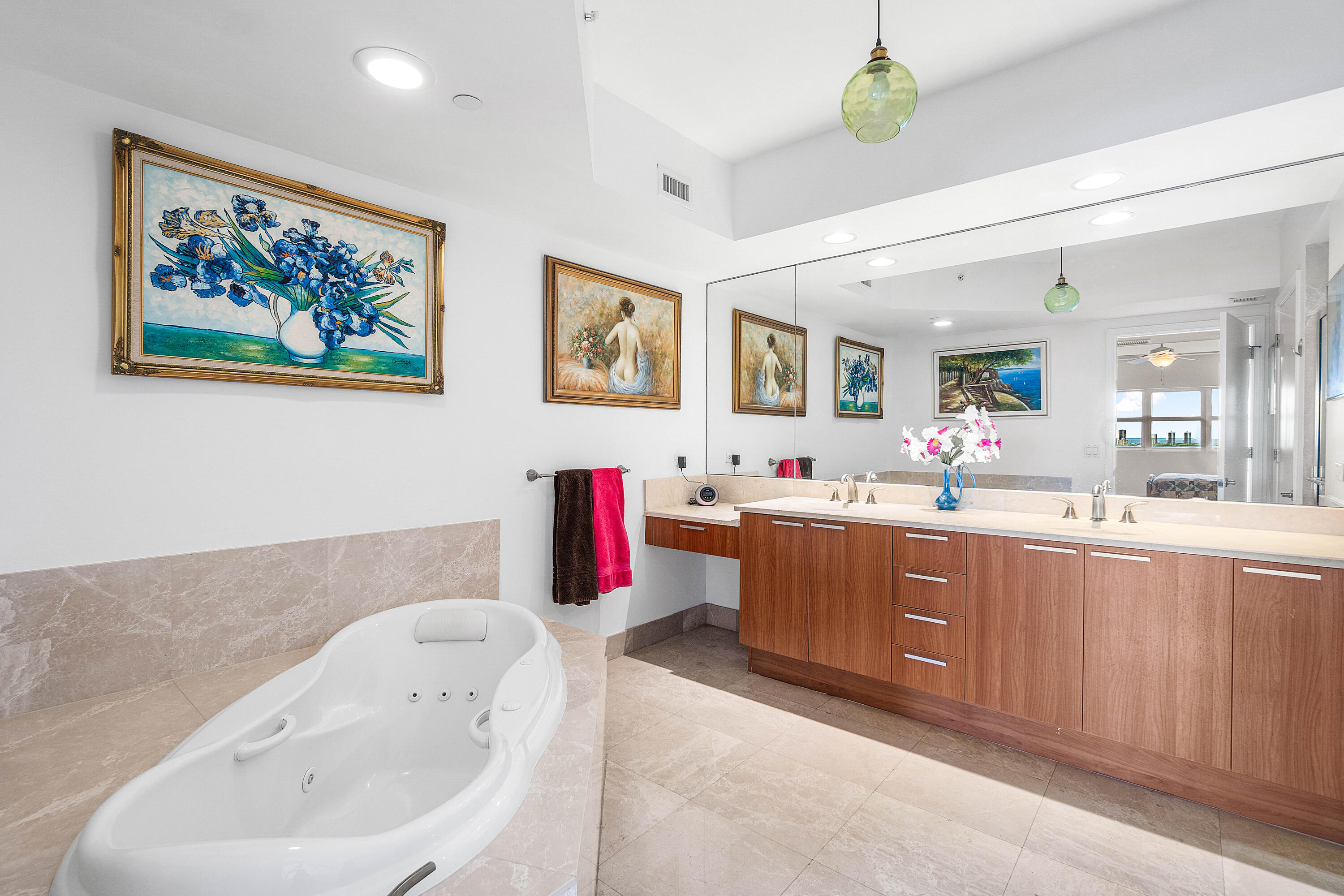 2650 Lake Shore Drive, Unit 1705 Riviera Beach, FL 33404 - Photo 14 of 35 a spacious bathroom with a tub double vanity sink and a mirror