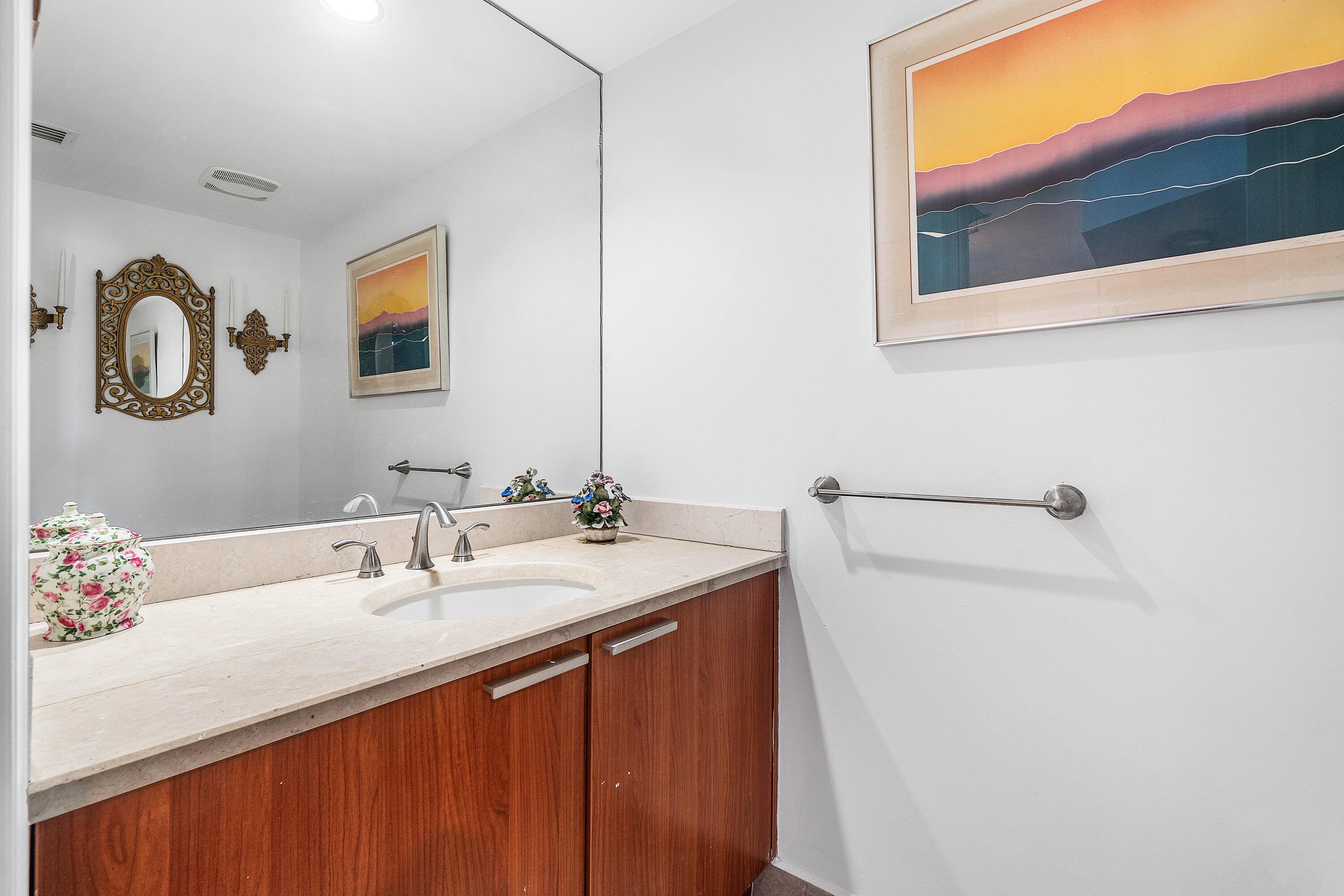 2650 Lake Shore Drive, Unit 1705 Riviera Beach, FL 33404 - Photo 16 of 35 a bathroom with a sink and a mirror