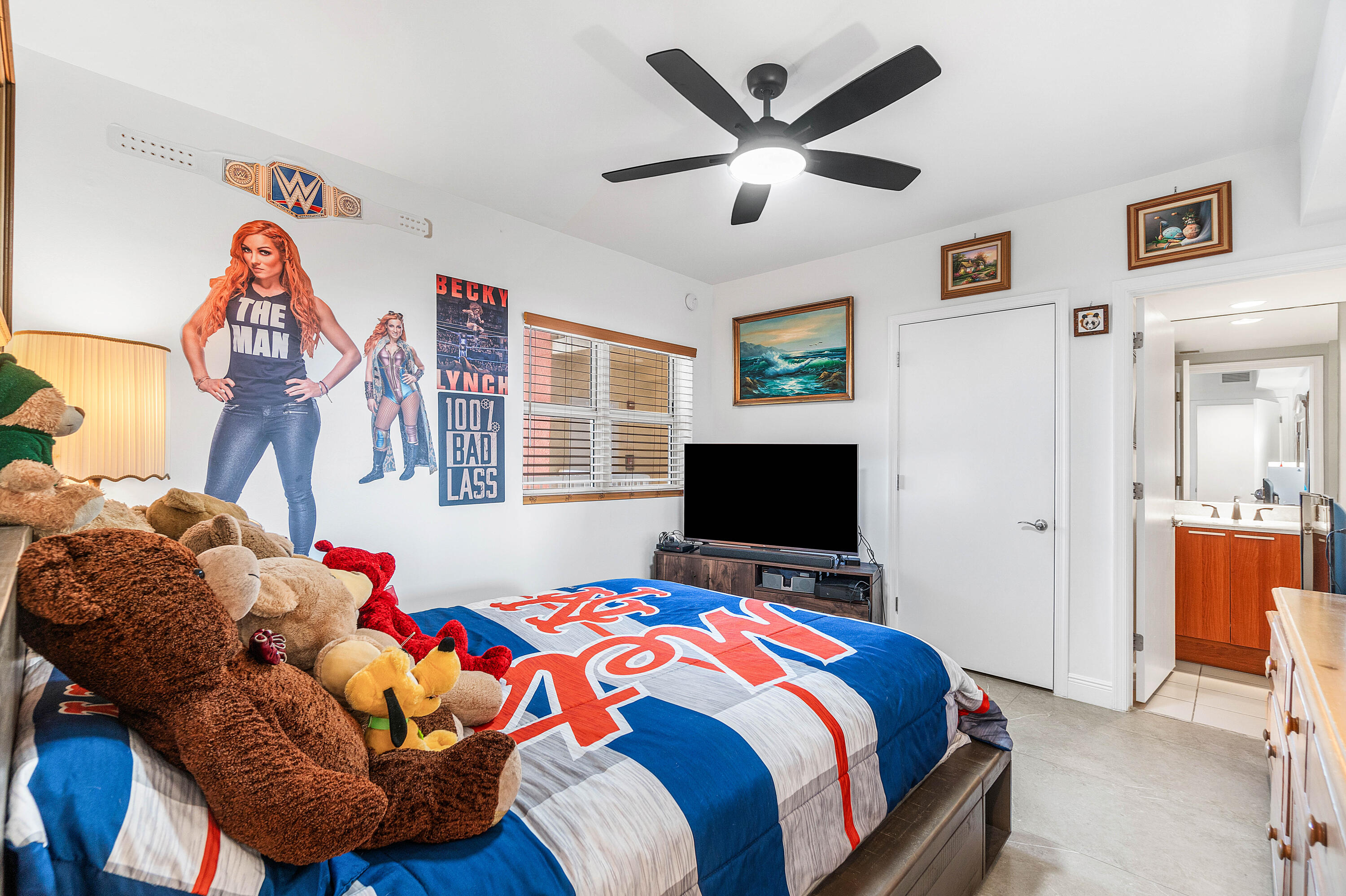 2650 Lake Shore Drive, Unit 1705 Riviera Beach, FL 33404 - Photo 17 of 35 a bedroom with a bed and a flat screen tv