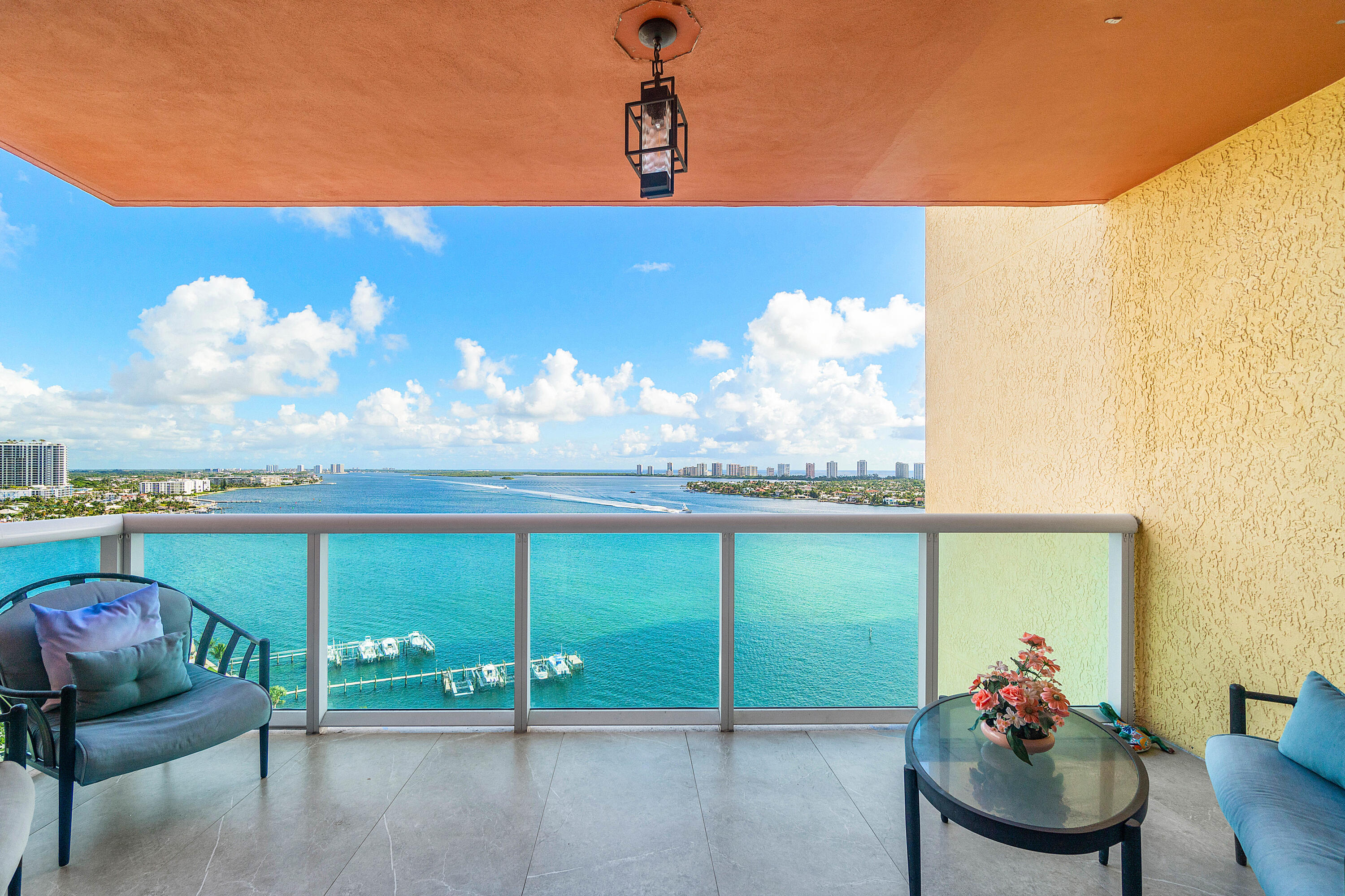 2650 Lake Shore Drive, Unit 1705 Riviera Beach, FL 33404 - Photo 19 of 35 a view of a chairs and table in the balcony