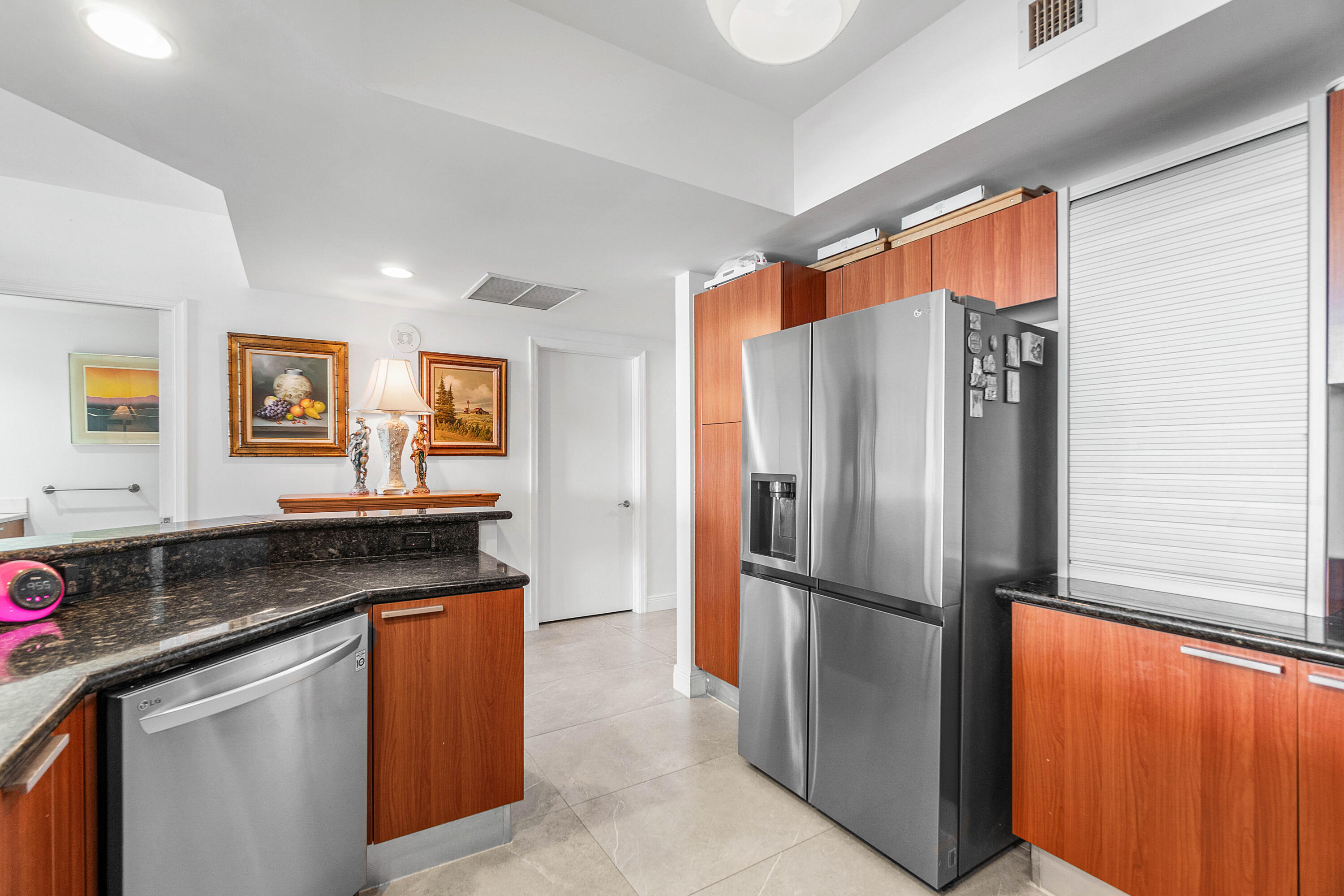 2650 Lake Shore Drive, Unit 1705 Riviera Beach, FL 33404 - Photo 2 of 35 a kitchen with granite countertop a refrigerator and a sink