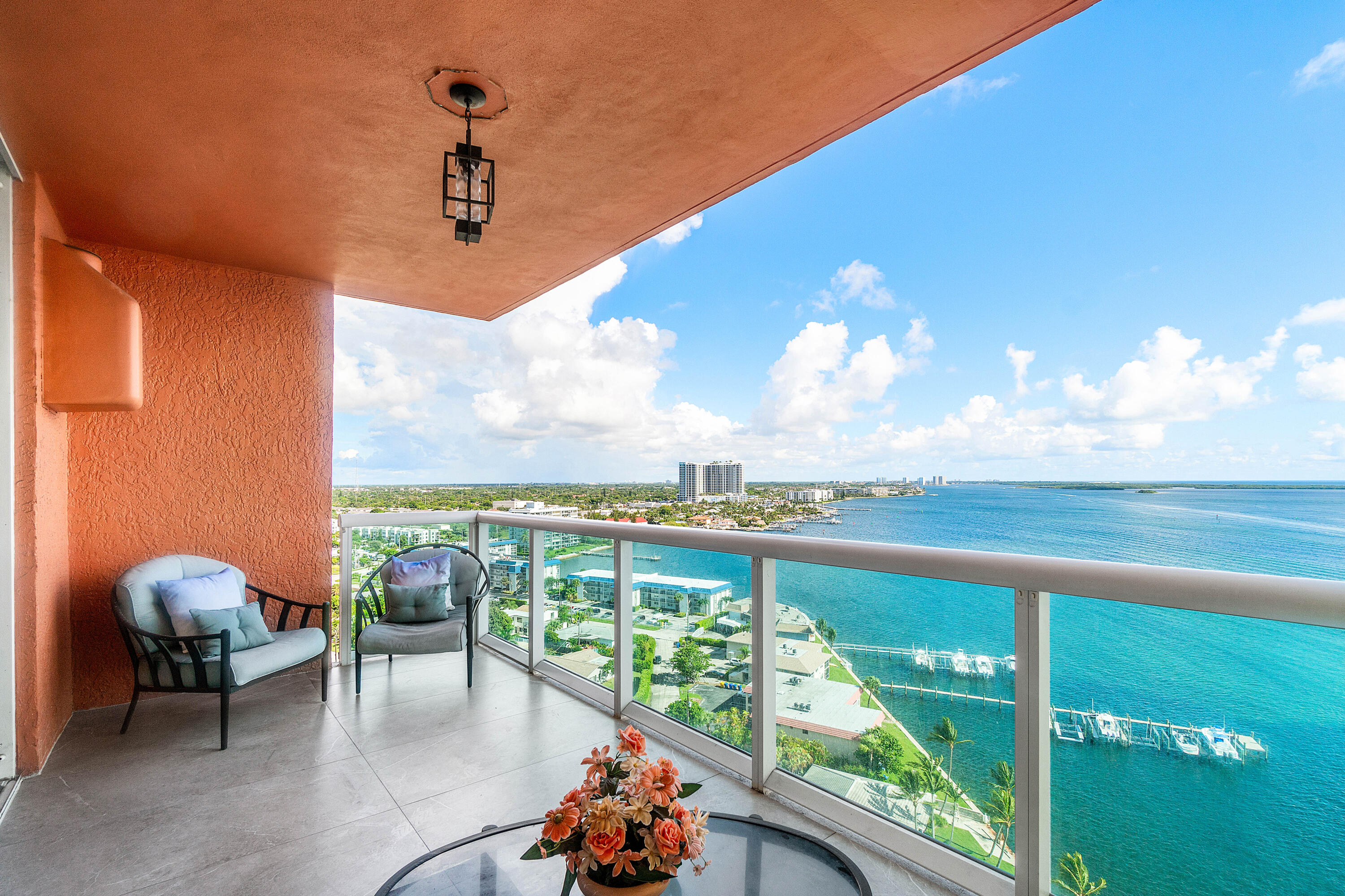 2650 Lake Shore Drive, Unit 1705 Riviera Beach, FL 33404 - Photo 21 of 35 a roof deck with table and chairs