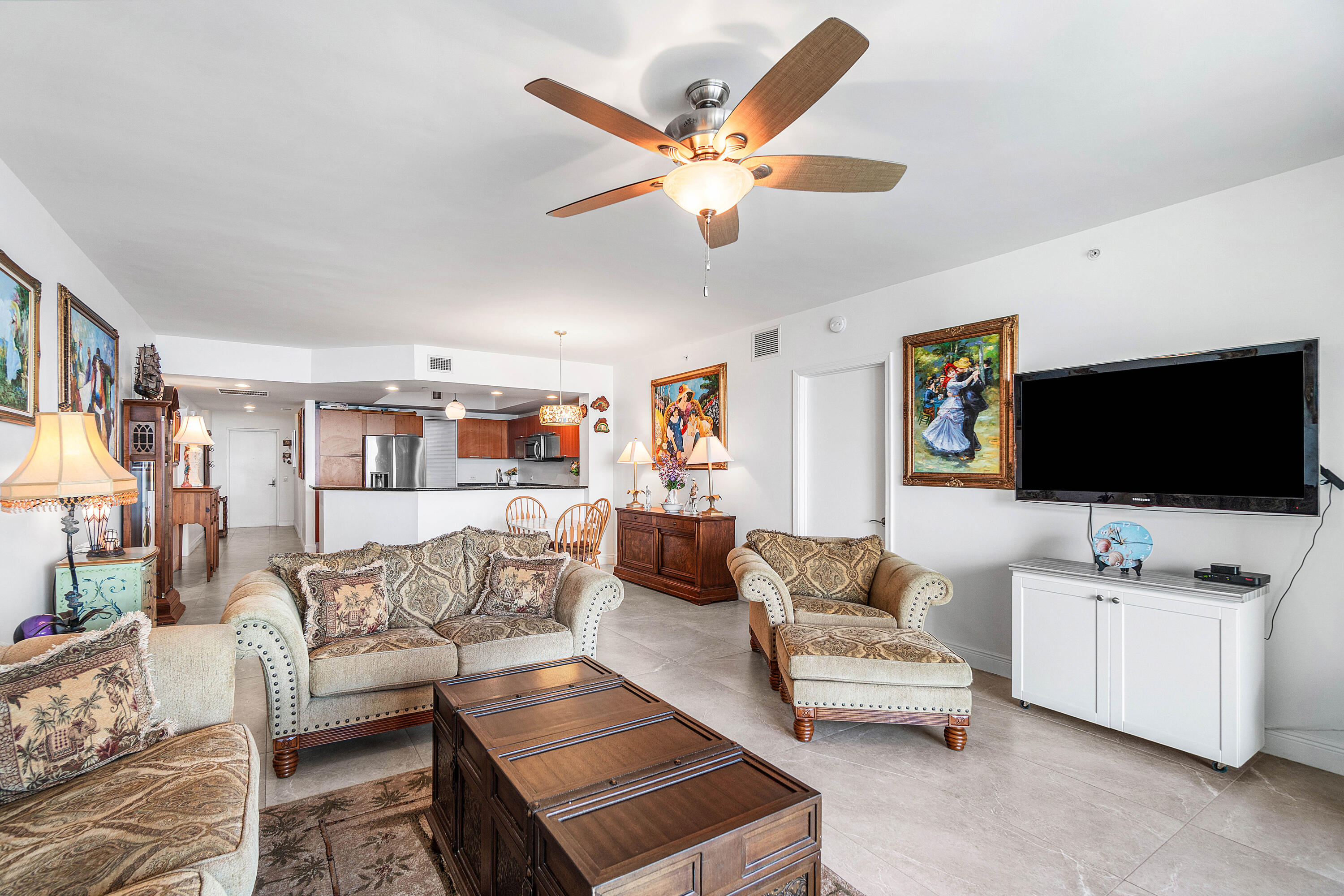 2650 Lake Shore Drive, Unit 1705 Riviera Beach, FL 33404 - Photo 9 of 35 a living room with furniture and a flat screen tv