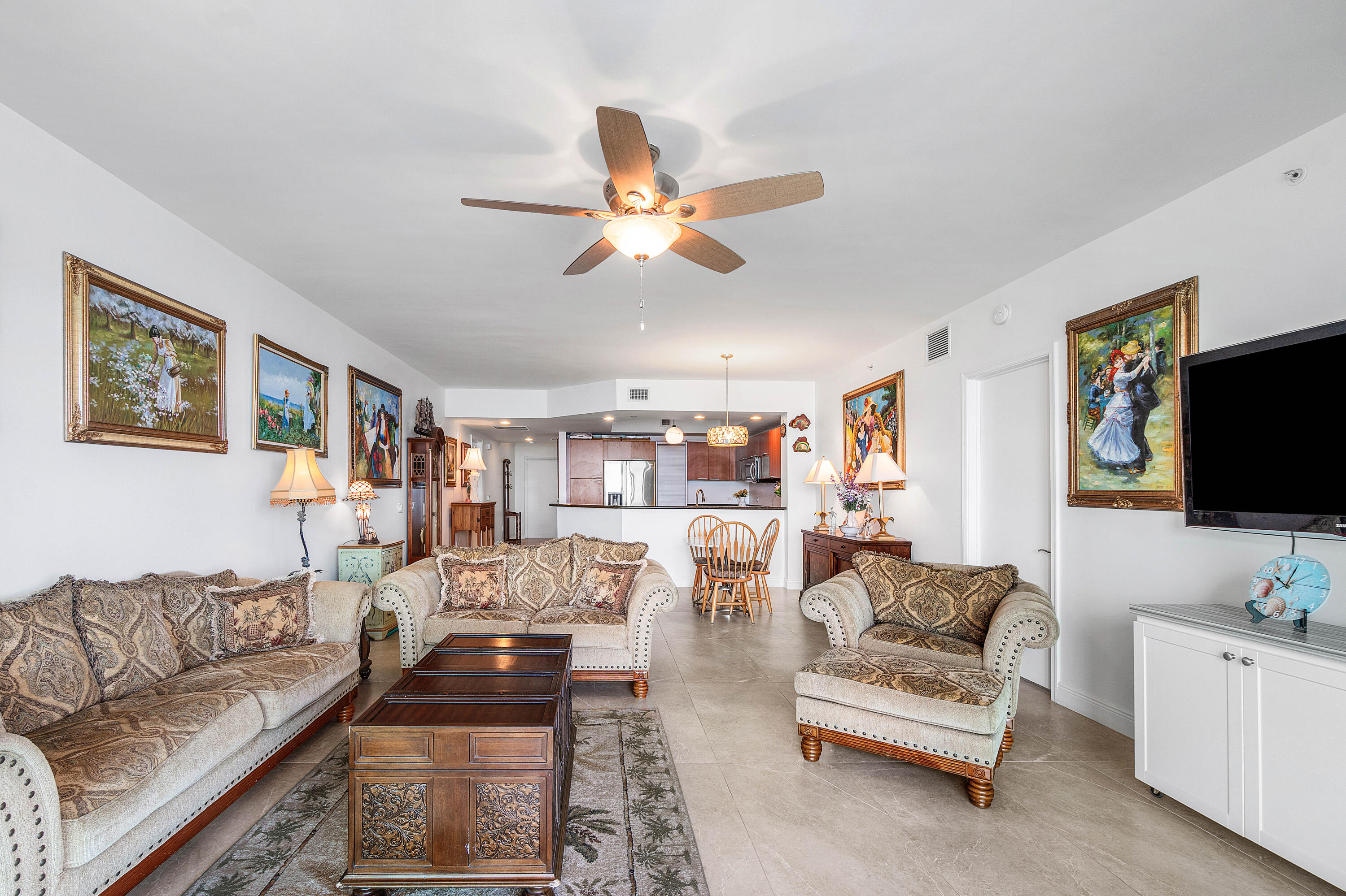 2650 Lake Shore Drive, Unit 1705 Riviera Beach, FL 33404 - Photo 10 of 35 a living room with furniture and a flat screen tv