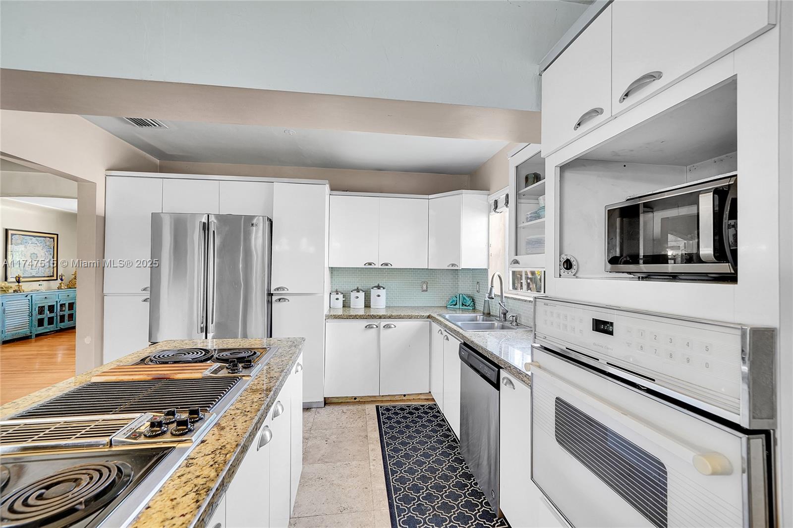 2271 Southwest 24th Terrace Miami, FL 33145 - Photo 11 of 23 a kitchen with a stove and a microwave