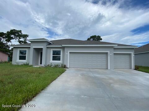 1643 Uniontown Street Southeast Palm Bay, FL 32909 - Photo 1 of 6 front view of a house with a yard