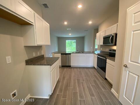 1643 Uniontown Street Southeast Palm Bay, FL 32909 - Photo 4 of 6 a kitchen with a sink and steel appliances