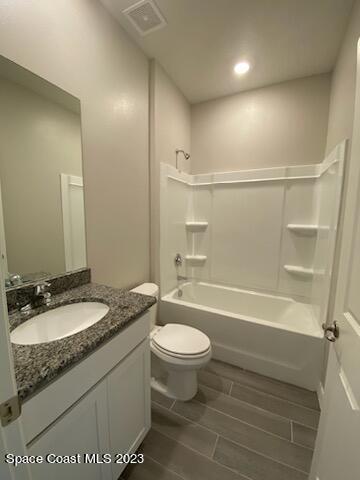1643 Uniontown Street Southeast Palm Bay, FL 32909 - Photo 6 of 6 a bathroom with a granite countertop sink a toilet a mirror and bathtub