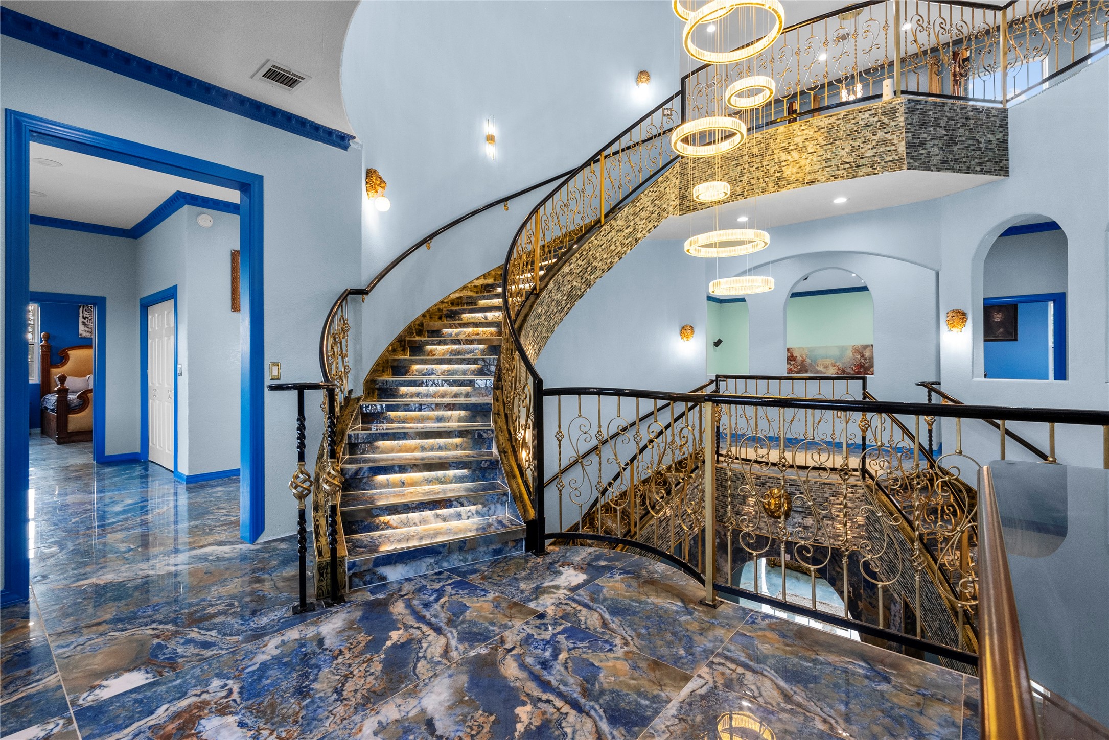1259 County Road 147 Alvin, TX 77511 - Photo 30 of 49 3rd floor staircase from 2nd floor landing area, lighted as you progress upward, with ultra modern chandelier. ornate handrails and mosaic tile compliment the staircase
