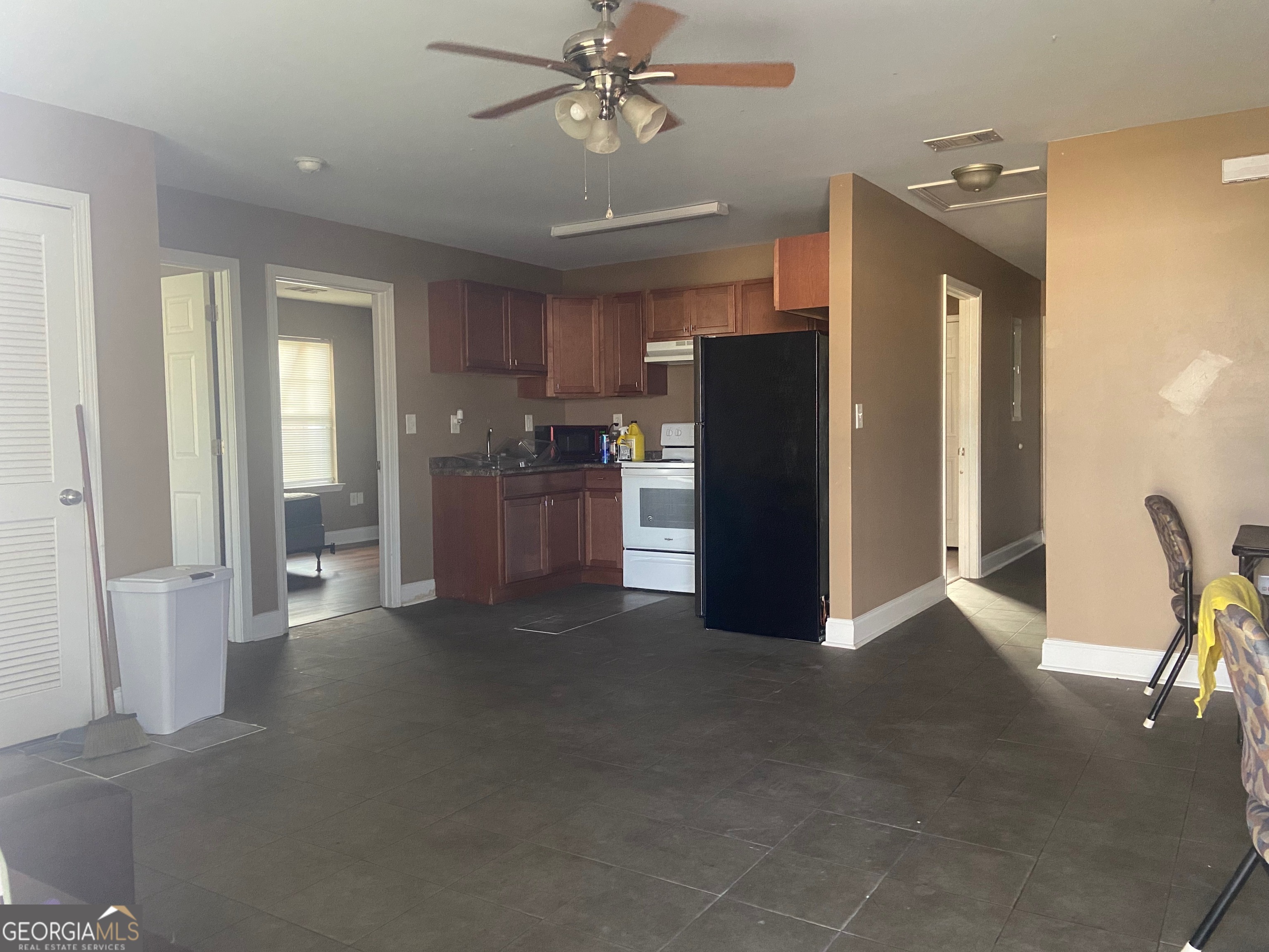 103 A Ronald Pride Boulevard Fort Valley, GA 31030 - Photo 2 of 9 a view of a kitchen with refrigerator and furniture