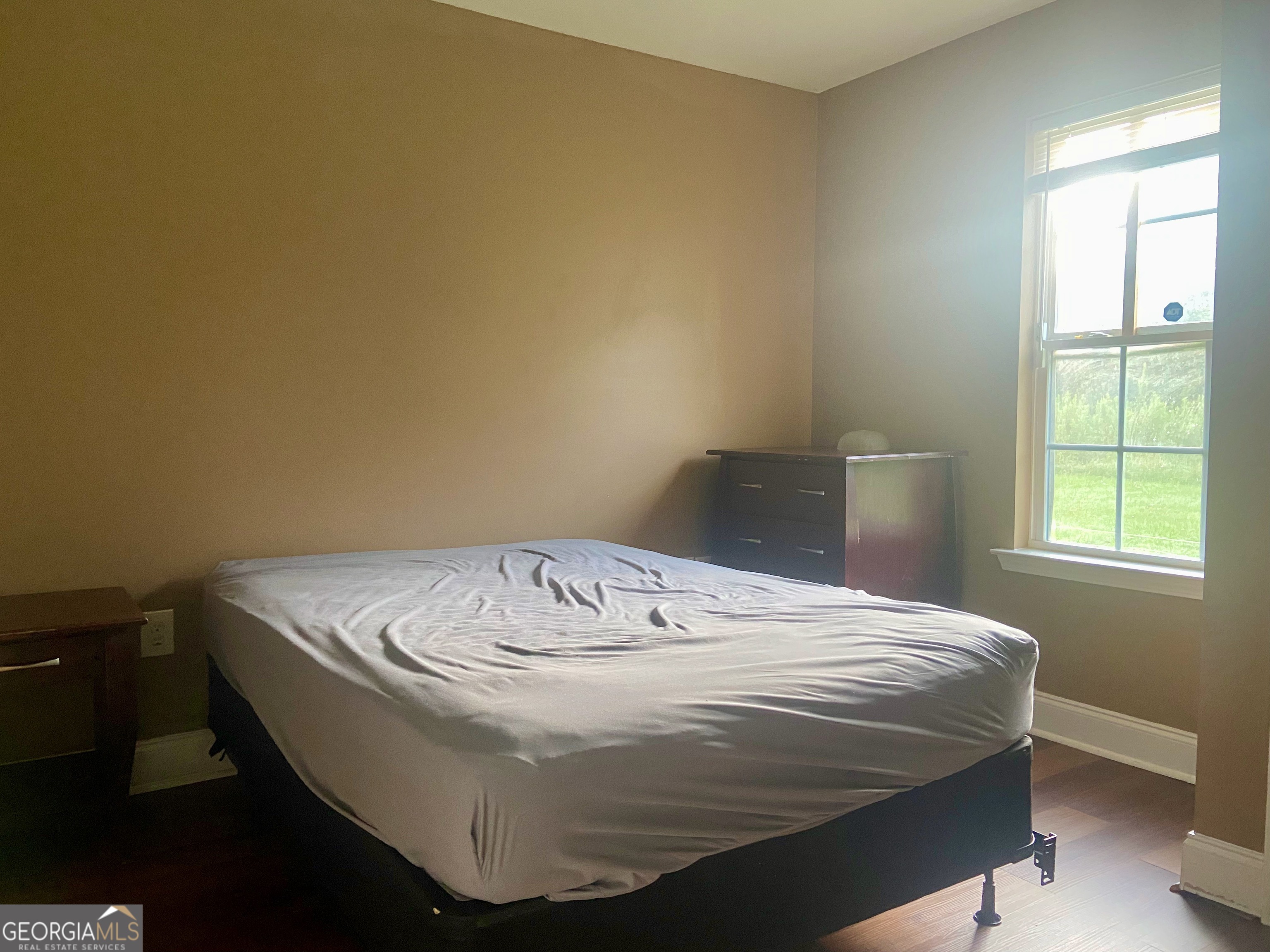 103 A Ronald Pride Boulevard Fort Valley, GA 31030 - Photo 4 of 9 a bed sitting in a bedroom next to a window