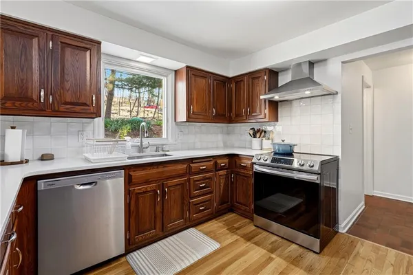 a kitchen with stainless steel appliances granite countertop a sink stove and cabinets