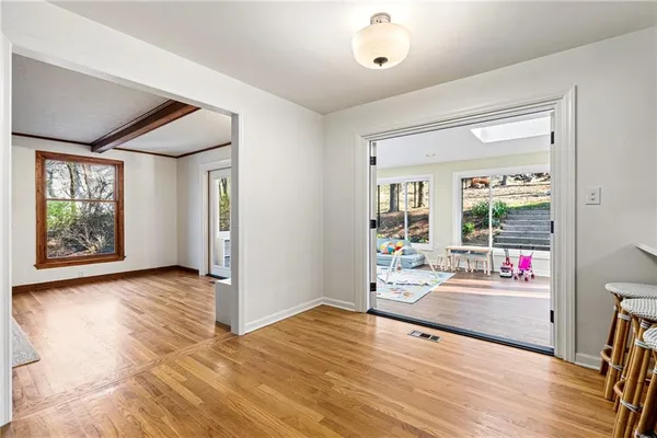 a view of a livingroom with wooden floor and a ceiling fan