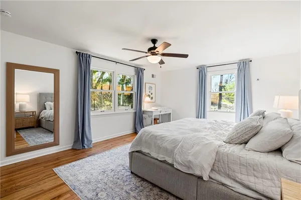 a bedroom with a balcony a bed and a window