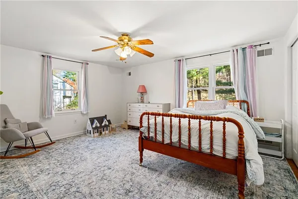 a bedroom with furniture and a window