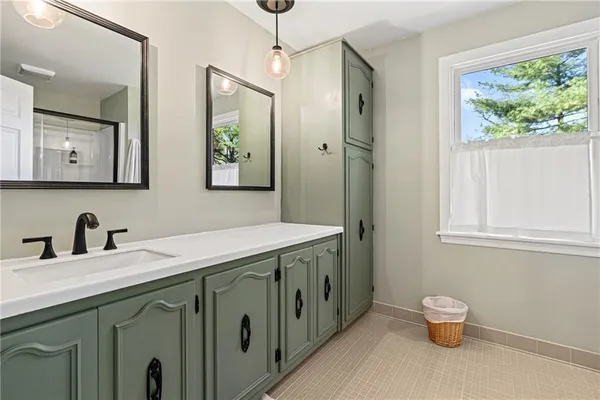 a bathroom with a granite countertop sink a toilet and a mirror