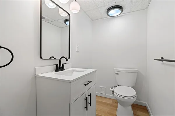 a bathroom with a toilet sink and mirror