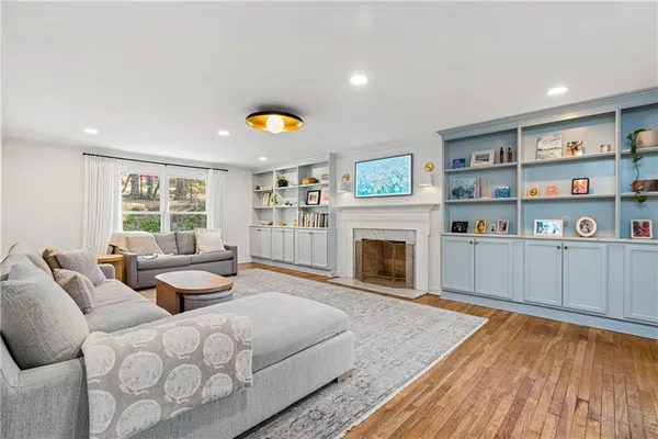 a living room with furniture and a fireplace