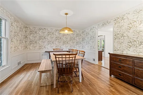 a view of a dining room with furniture window and wooden floor