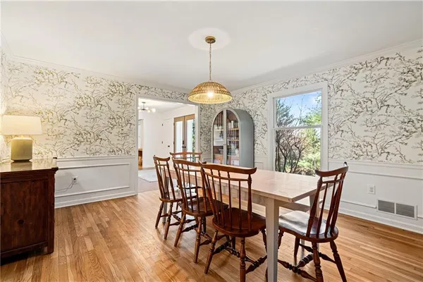 a dining room with furniture and window
