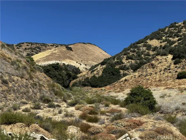 a view of a large mountain with mountains in the background