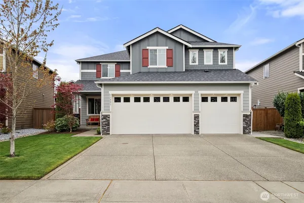 a front view of a house with a yard and garage
