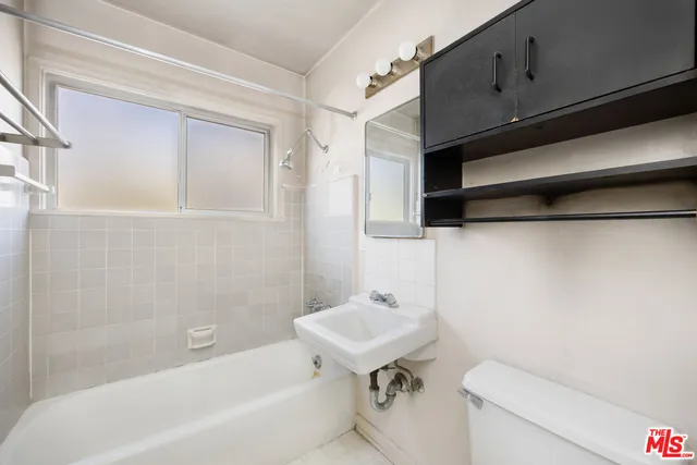 a bathroom with a sink a toilet and bathtub