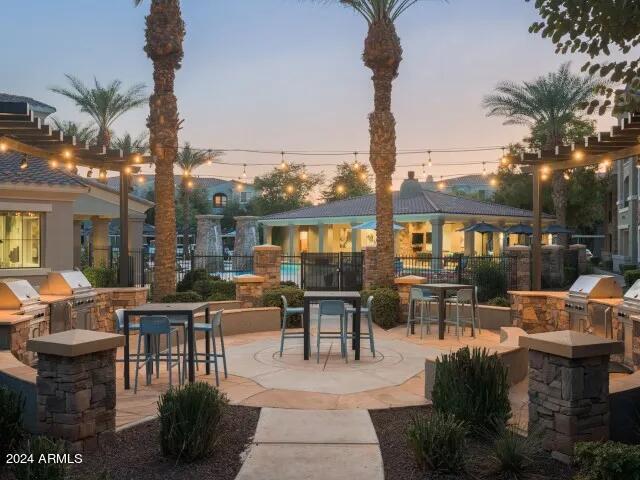 2910 South Greenfield Road, Unit C1 Gilbert, AZ 85295 - Photo 4 of 7 a view of a patio with couches table and chairs potted plants and palm tree