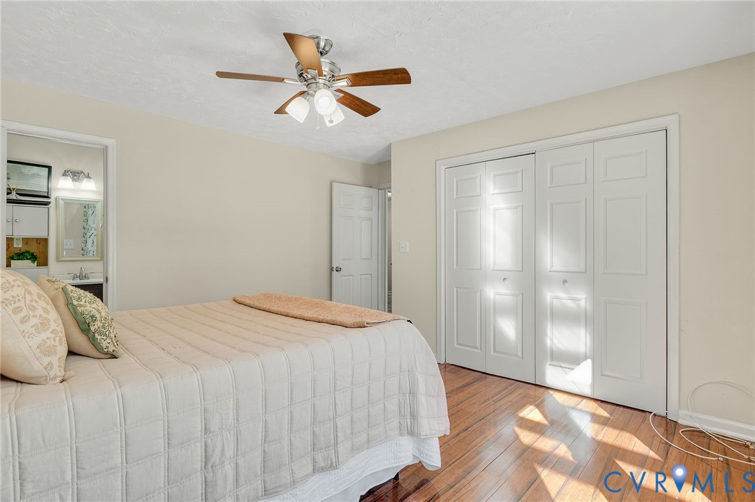 19011 Matoaca Road Petersburg, VA 23803 - Photo 16 of 44 a bedroom with a large bed and a chandelier