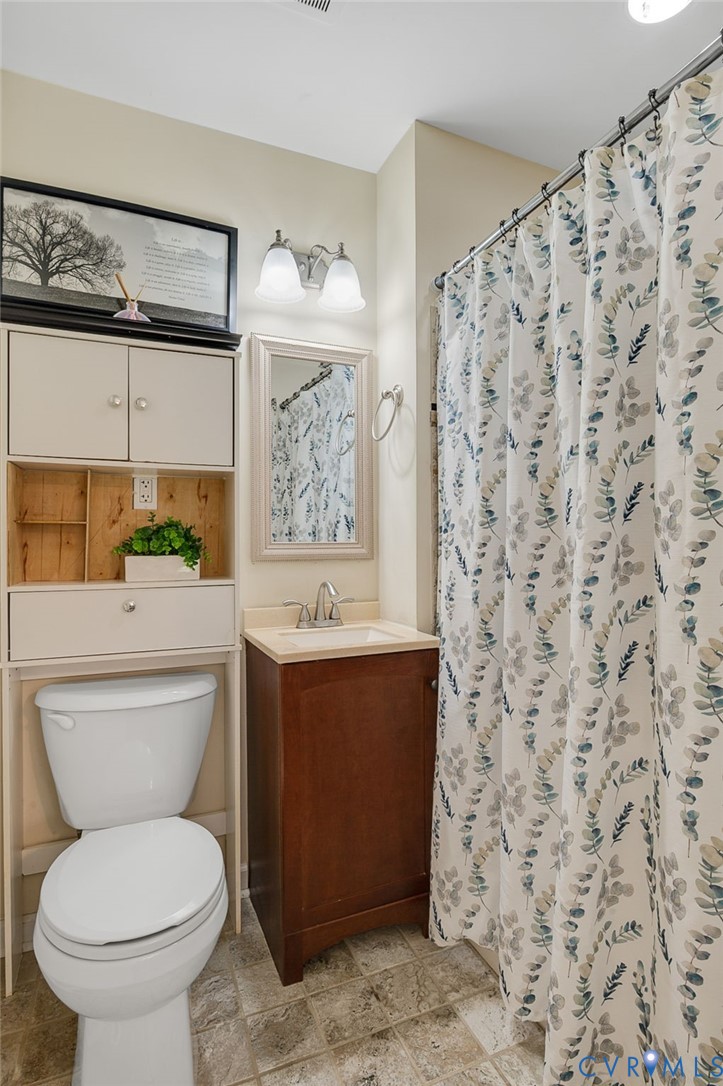 19011 Matoaca Road Petersburg, VA 23803 - Photo 17 of 44 Bathroom featuring curtained shower, vanity, and l