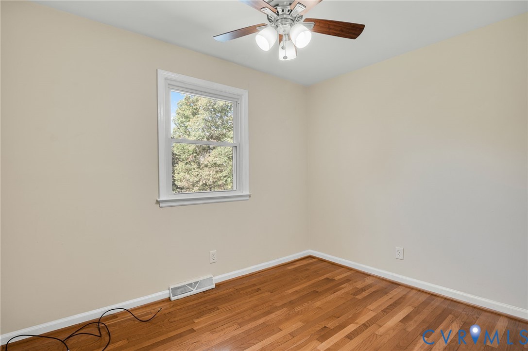 19011 Matoaca Road Petersburg, VA 23803 - Photo 18 of 44 an empty room with a window and wooden floor