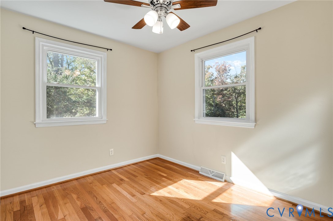 19011 Matoaca Road Petersburg, VA 23803 - Photo 20 of 44 a view of a bedroom with wooden floor and chandelier fan