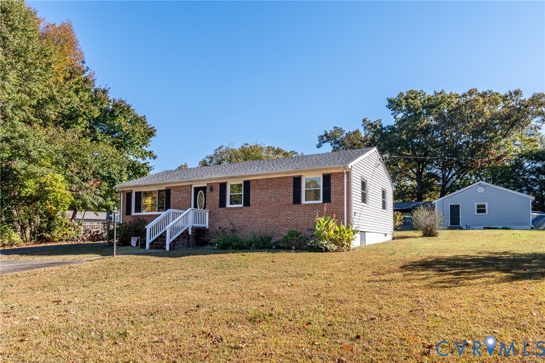 19011 Matoaca Road Petersburg, VA 23803 - Photo 27 of 44 a front view of a house with a yard and trees