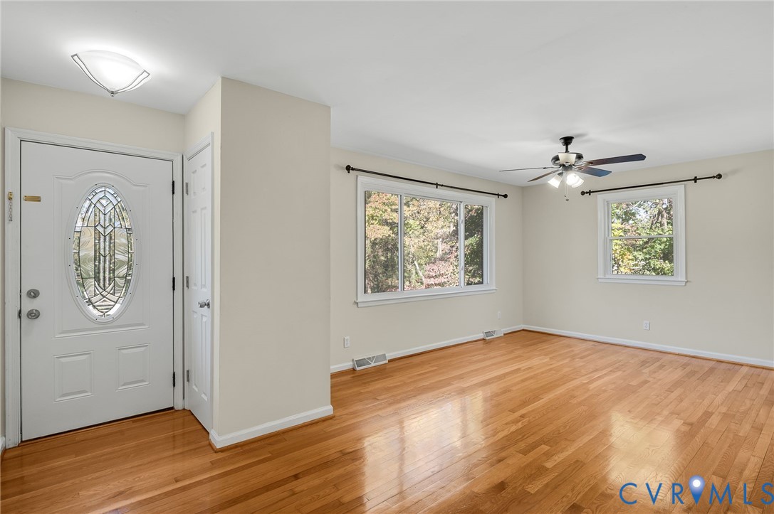 19011 Matoaca Road Petersburg, VA 23803 - Photo 3 of 44 an empty room with wooden floor closet and windows