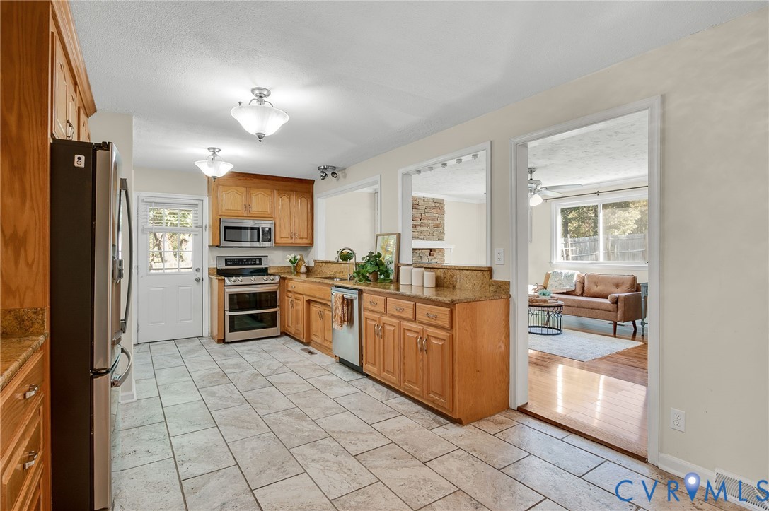 19011 Matoaca Road Petersburg, VA 23803 - Photo 6 of 44 a kitchen with stainless steel appliances a refrigerator and microwave
